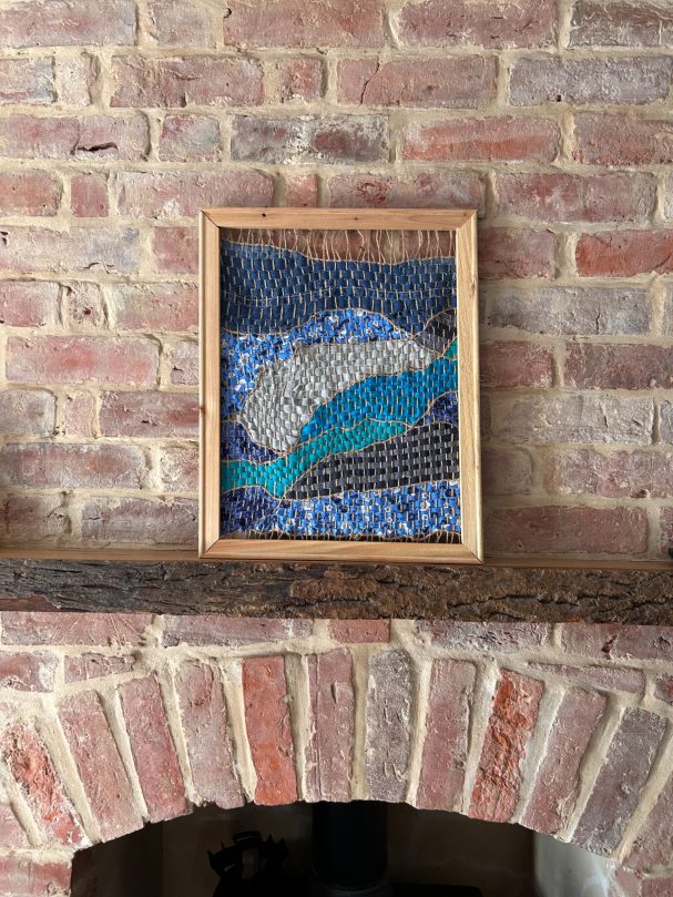 Weaved piece with turquoise coloured materials 